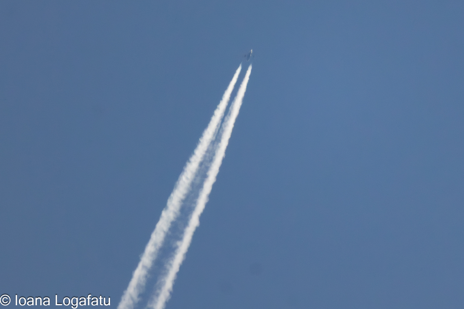 High altitude jet leaves a trail in the bright sky
